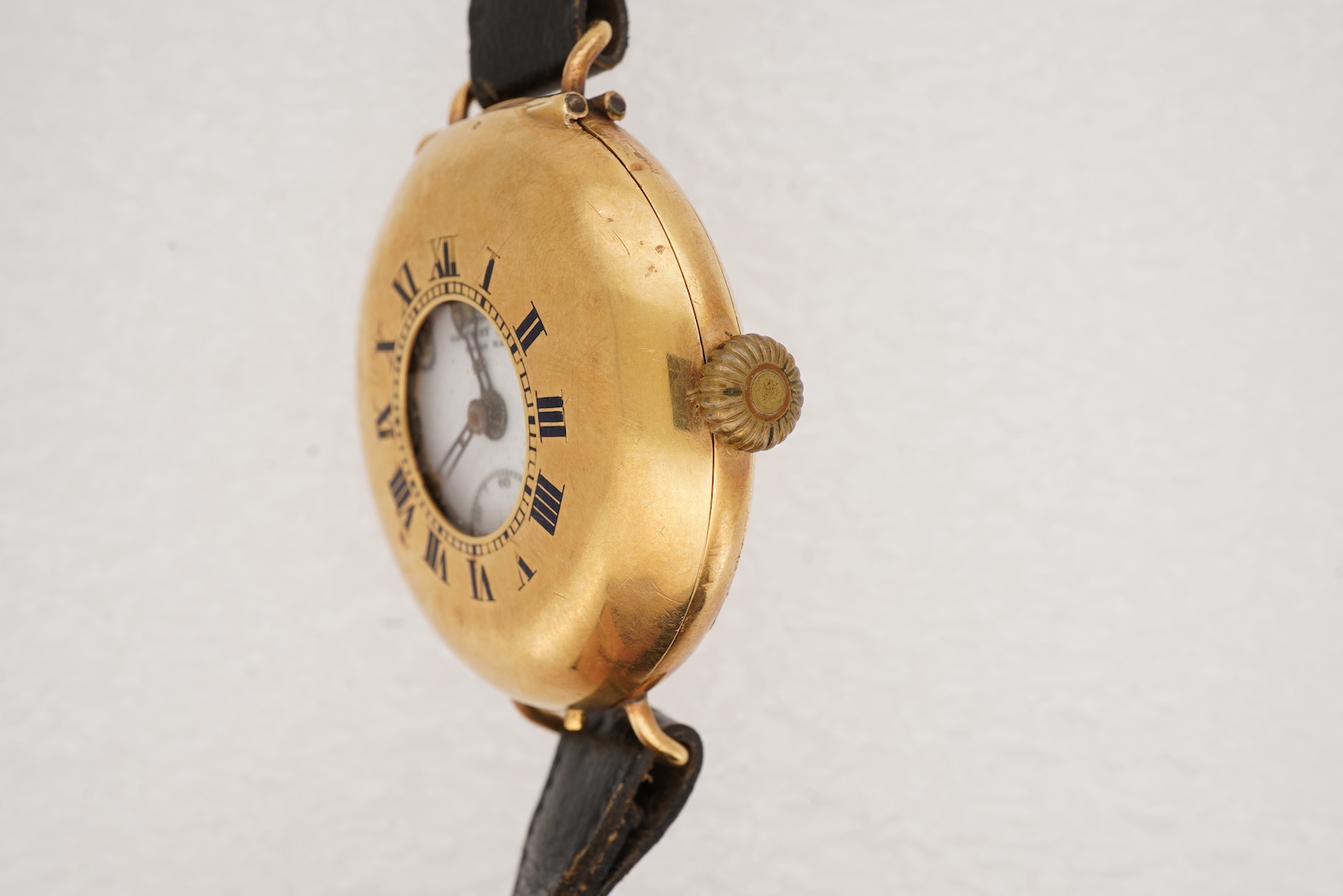 A gentleman's early to mid 20th century 18ct gold half hunter Coventry lever manual wind wrist watch